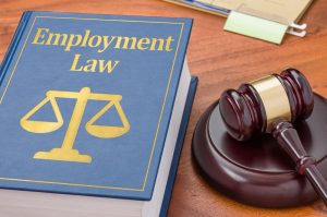 Employment law book paired with a judge's gavel.