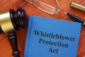 The Whistleblower Protection Act is depicted in a conceptual photo with the text prominently displayed.