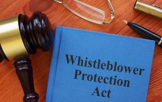 The Whistleblower Protection Act is depicted in a conceptual photo with the text prominently displayed.